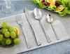 A table setting with cutlery, grapes, and a salad. Voir les images du produit
