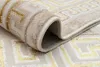 A close-up view of a rolled-up rug with a geometric pattern. Produktbild-Vorschau