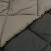 Close-up view of a quilted blanket with two different colored sections. Náhľad obrázku produktu