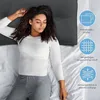A woman sleeping on a bed with a pillow, next to marketing graphics. Produktbild-Vorschau