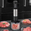 A multi-functional hand blender is shown on a kitchen counter, surrounded by plates of raw meat, suggesting its use for food preparation. Podgląd zdjęcia produktu