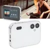 A digital camera is shown in two views, one with a screen displaying a media player interface and another showing the back of the camera. A person is holding a similar device with headphones in the background. Podgląd zdjęcia produktu