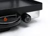 A close-up shot of a black and silver electric grill's control knob and handle. Produktbild-Vorschau