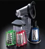 A set of kitchen appliance attachments, including graters and a slicer, displayed against a black background. Produktbild-Vorschau