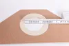 A close-up of a vacuum cleaner bag with a measuring tape across a circular opening. Produktbild-Vorschau
