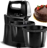 A black hand mixer with two bowls and a chocolate cake are shown. Produktbild-Vorschau