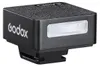 A close-up studio shot of a black Godox iM20 mini on-camera speedlite. Podgląd zdjęcia produktu