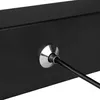 A close-up shot of a black surface with a silver circular fitting and a black cable plugged into it. Produktbild-Vorschau