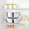 Inside a refrigerator, showing various food storage containers and some eggs and onions. Produktbild-Vorschau
