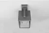 A gray outdoor wall lamp with a glass enclosure is mounted on a white wall. Anteprima dell’immagine prodotto