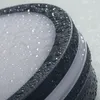 Close-up of a dark gray, oval-shaped light fixture with water droplets on its surface. Náhľad obrázku produktu