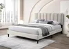 A bed with a beige upholstered headboard and frame is shown in a well-lit room. Náhľad obrázku produktu