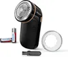 A Philips fabric shaver with accessories, including batteries, a protective cap, and a cleaning brush, is displayed against a white background. Produktbild-Vorschau