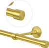 A close-up view of a brass gold curtain rod with end caps and a wall mount. Anteprima dell’immagine prodotto