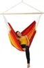A woman is relaxing in a colorful hammock chair. Náhled obrázku produktu