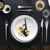 A formal table setting with a plate of food, cutlery, and a glass of wine. Voir les images du produit