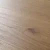 A close-up view of a wooden surface with a knot. Produktbild-Vorschau