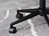 Close-up of the black casters and legs of an office chair on a patterned rug. Produktbild-Vorschau