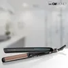 A black and gold hair straightener is displayed on a white surface with a blurred background. Náhľad obrázku produktu