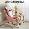 A woman is relaxing in a pink rocking chair, reading a book. Náhled obrázku produktu
