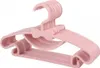 A stack of pink children's hangers with a bow detail. Produktbild-Vorschau
