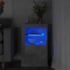 A modern bedside cabinet with LED lighting, displaying two mugs and books on its shelves. Voir les images du produit