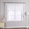 A white sheer curtain with a scalloped hem and satin trim hangs across a window. Produktbild-Vorschau