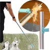 A person is using a cleaning brush to remove pet hair from a carpet, with a cat and a dog nearby. Náhled obrázku produktu