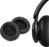 Two black ear pads for headphones are shown on a white background, with a portion of a black headphone visible on the right. Anteprima dell’immagine prodotto
