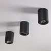 Three black cylindrical LED ceiling lights are mounted on a white ceiling. Produktbild-Vorschau