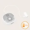 A white and gray baby sound machine with a white USB cable plugged into a white charging adapter, set against a light beige background. A circular orange graphic with a battery icon and '24h' is in the lower right corner. Náhľad obrázku produktu