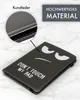 A black tablet case with a cartoon face and text is shown on a marble background. A close-up inset shows the material and stitching. Produktbild-Vorschau
