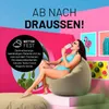 A woman in a bikini sits on a beanbag chair, eating an ice cream, with colorful artwork in the background. Produktbild-Vorschau