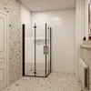 A modern bathroom with a black-framed glass shower enclosure. Produktbild-Vorschau