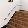 A stainless steel handrail is installed on a wall next to a wooden staircase. Produktbild-Vorschau
