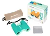 A set of children's binoculars and accessories, including a carrying pouch and cleaning cloth, laid out on a white background next to the product packaging. Náhľad obrázku produktu