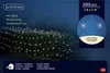 A net of warm white LED lights is draped over a dark green bush at night. Produktbild-Vorschau