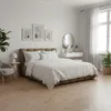 A bedroom with a bed, nightstand, chair, and window. Produktbild-Vorschau