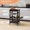 A kitchen cart is shown in a kitchen setting with labels pointing out its features. Náhled obrázku produktu