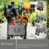 A family with a dog is using a foldable wagon outdoors. Produktbild-Vorschau