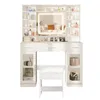 A white vanity table with a lighted mirror, multiple shelves, drawers, and a stool, all against a white background. Voir les images du produit