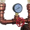 Close-up of a retro-style industrial pipe lamp with a pressure gauge and a red valve. Náhled obrázku produktu
