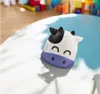 A cow-shaped humidifier sits on a table with a blurred background of toys. Anteprima dell’immagine prodotto