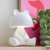 A white bear-shaped lamp sits on a shelf. Náhled obrázku produktu