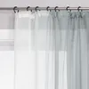 Close-up of sheer curtains hanging from a curtain rod. Produktbild-Vorschau