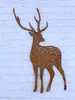 A rusty metal deer decoration is mounted on a white brick wall. Produktbild-Vorschau