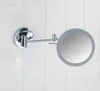 A chrome magnifying mirror with LED lighting is mounted on a white tiled wall. Produktbild-Vorschau