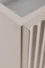 Close-up of the corner of a beige cabinet with fluted detailing. Produktbild-Vorschau