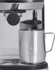 Close-up of an espresso machine's steam wand and milk frothing pitcher. Produktbild-Vorschau
