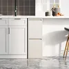 A modern kitchen scene with white cabinets and a trash can. Anteprima dell’immagine prodotto